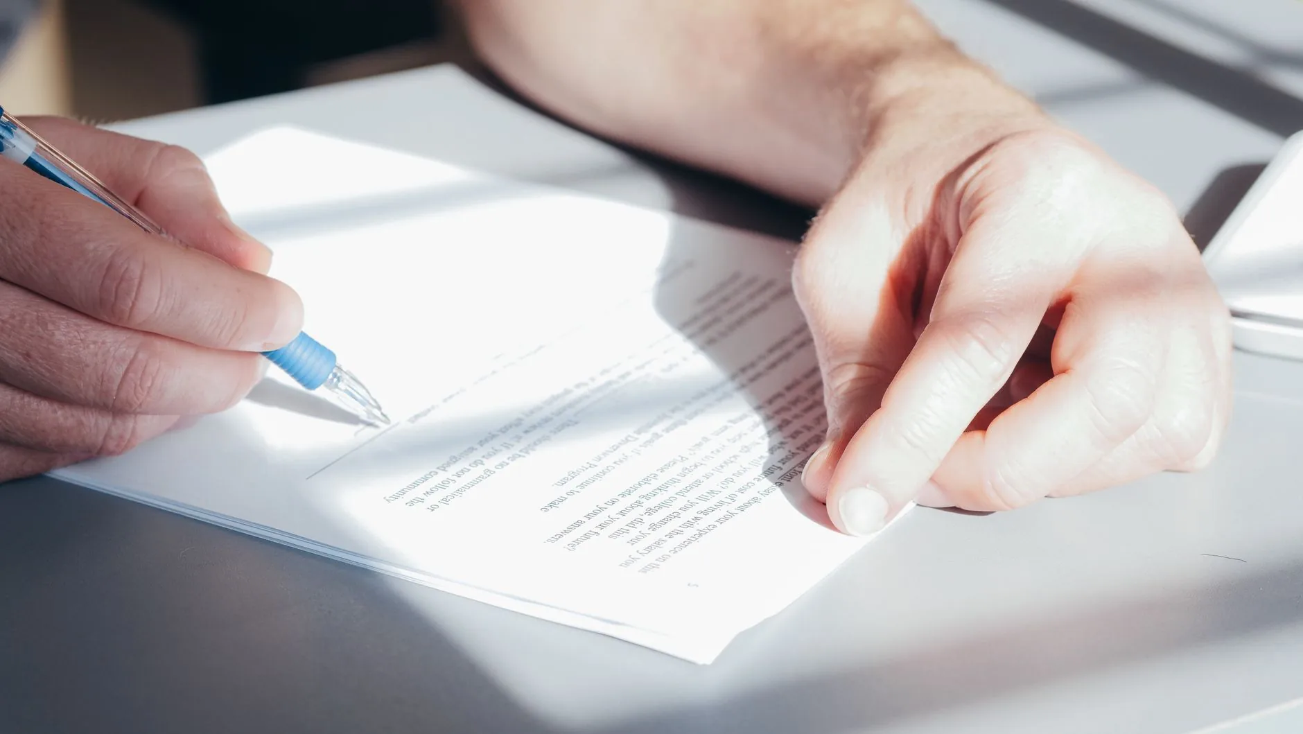 A hand hovers over a wireless key, accessing the IRS portal, muted colors.